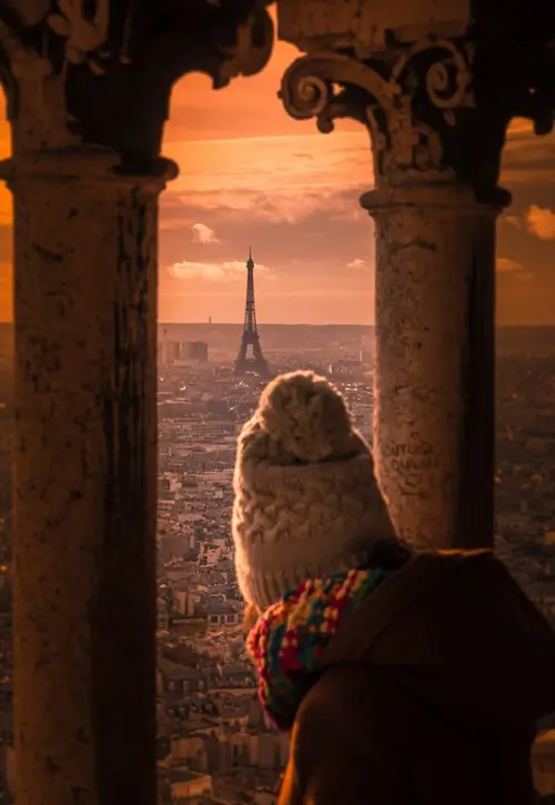 A woman enjoying the view of Eiffel Tower in Paris, France.
